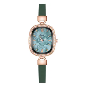 Macro view of oval rose gold watch with cyan marble dial and diamond-set bezel