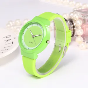 Macro view of neon green quartz watch with silicone strap and minimalist white dial design