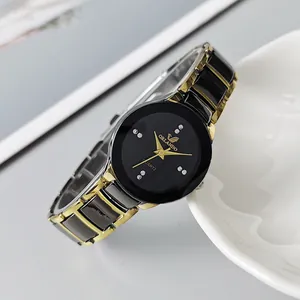 Macro detail of elegant black and gold quartz watch dial with sparkling rhinestone markers