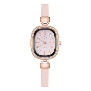 Macro shot of rose gold oval case with rhinestones and pink leather strap on Tadi watch