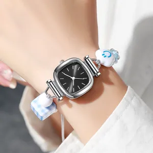 Women's watch with square black dial and blue beaded bracelet featuring a cloud charm