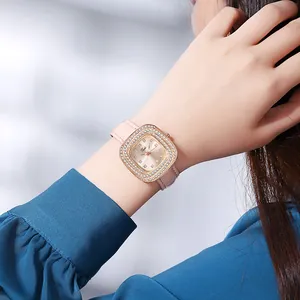 Detail of luxury ladies quartz watch with rhinestone bezel and pink leather strap