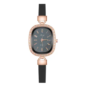 Detailed close-up of oval rose gold watch case with crystal bezel and grey sunray dial