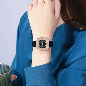 Detailed macro view of square rose gold watch case with double diamond bezel on wrist