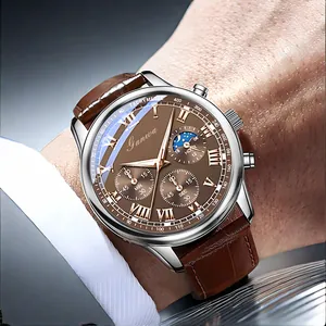 Detail of chronograph watch with brown dial, leather strap, and moon phase display
