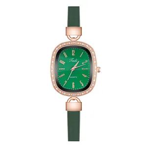 Detail view of oval emerald green watch face with crystal bezel and rose gold case