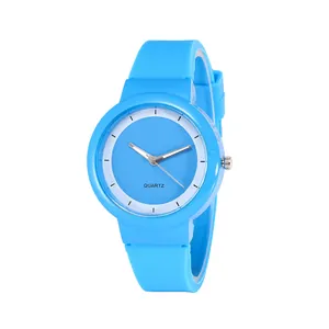 Minimalist bright blue quartz watch with silicone strap and round dial on white background