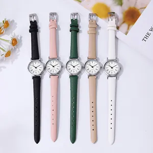Flat lay of five minimalist quartz watches with colorful straps and Roman numerals