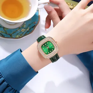 Close-up of elegant women's quartz watch with green square dial and crystal bezel