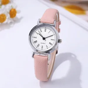 Close-up of minimalist women's quartz watch with pink leather strap and Roman numerals