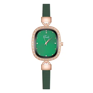 Detail of rose gold oval watch with crystal-encrusted bezel and green emerald dial
