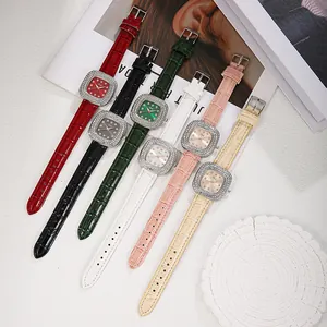 Close-up of elegant square quartz watches with diamond bezels and crocodile leather straps