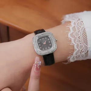 Close-up of elegant square quartz watch with double-row crystals and black leather strap
