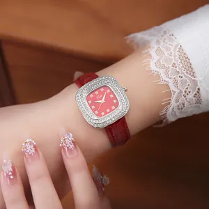 Close-up of a square women's quartz watch featuring a red dial and diamond-set bezel