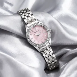 Detail of a ladies' quartz watch with pink floral dial, rhinestone bezel and silver band