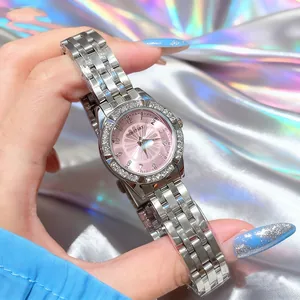 Detail of silver stainless steel watch strap and pink sunray dial with crystal bezel