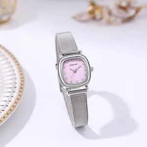 Close-up of elegant square silver mesh watch featuring a soft pink crystal dial