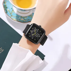Close-up of a stylish square quartz watch with black silicone strap on a female wrist