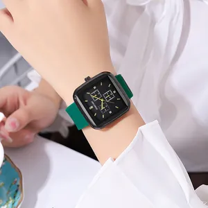 Close-up of a women's square quartz watch with a green silicone strap and black dial