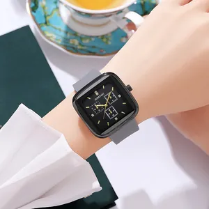 Close-up of a square black dial quartz watch with gray silicone strap on a wrist