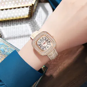 Elegant ladies quartz watch with diamond bezel and cream leather strap on wrist