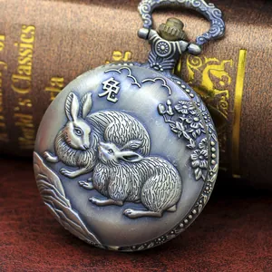 Detail of vintage pocket watch cover with rabbit relief and antique silver finish