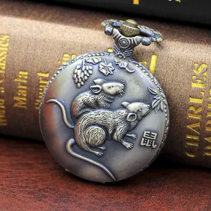 Detailed relief carving of a zodiac rat and vine pattern on antique bronze pocket watch