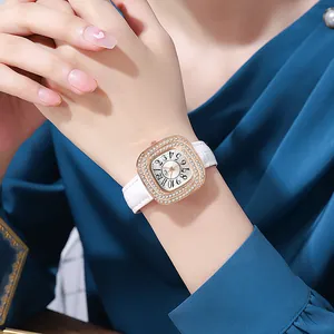 Close-up of elegant rose gold square quartz watch with crystal bezel and leather strap
