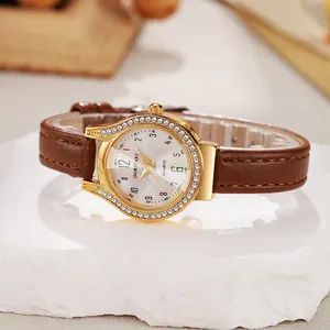 Detail of luxury gold watch with diamond bezel, colorful mother of pearl dial and leather strap