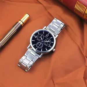 Close-up of a men's quartz watch with black dial and steel strap on a business desk