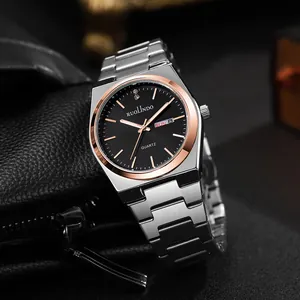 Detail view of business watch with dual calendar display and silver stainless steel strap