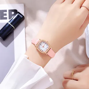 Nahaufnahme einer Damen-Quarzuhr in Roségold mit rosa Lederarmband am Handgelenk