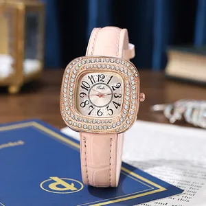 Detail of rose gold square watch featuring diamond bezel and pink leather strap texture
