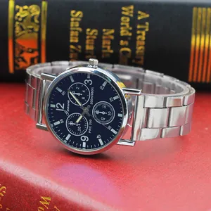 Macro shot of silver steel quartz watch with deep blue dial on vintage books