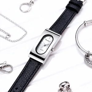 Macro shot of rectangular silver quartz watch with black leather strap and metal jewelry