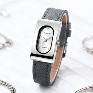 Macro shot of rectangular silver quartz watch with grey leather strap and white dial