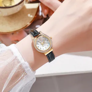 Detailed close-up of a women's gold watch with rainbow dial and crystal bezel