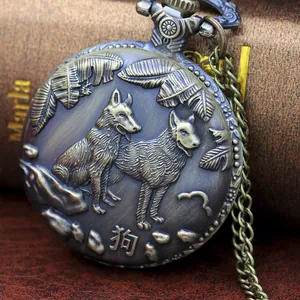 Macro shot of bronze zodiac pocket watch featuring a detailed relief of two hunting dogs