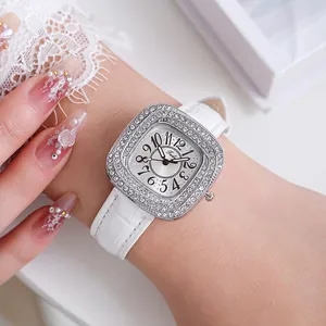 Close-up of square diamond watch for women with white leather strap and sunray dial