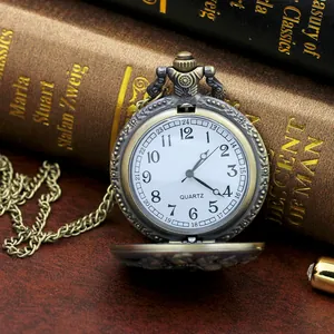 Detail of bronze zodiac pocket watch resting on vintage book with antique carvings