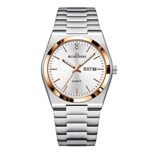 Macro view of men's quartz watch with dual calendar display and silver stainless steel strap