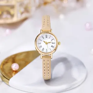 Detail of elegant gold case watch with Roman numeral dial and beige leather strap