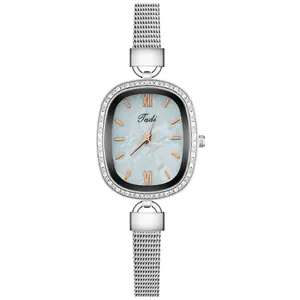 Detail of oval dial with pearlescent texture and silver mesh band women watch