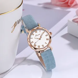 Detail van roségoud quartz horloge met witte Romeinse wijzerplaat en lichtblauwe band