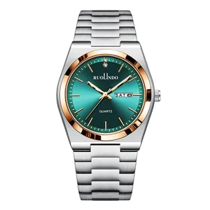 Close-up of green gradient dial with dual calendar display and silver steel band