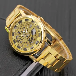 Classic gold hollow mechanical watch with roman numerals on black leather surface