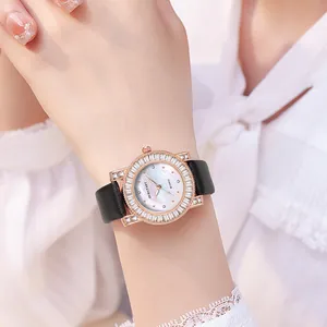 Close-up of luxury women's quartz watch with shell dial and sparkling crystal bezel