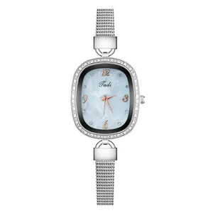 Detail of elegant oval quartz watch with silver mesh band and crystal bezel decoration