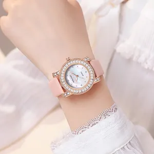 Close-up of elegant women's watch with rose gold crystal bezel and pink leather strap
