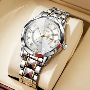 Detailed close-up of quartz watch with silver gold band and dual calendar display
